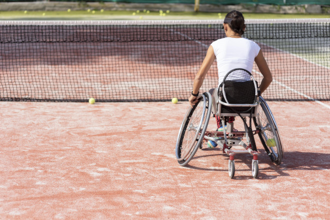 Full shot disabled woman playing tennis