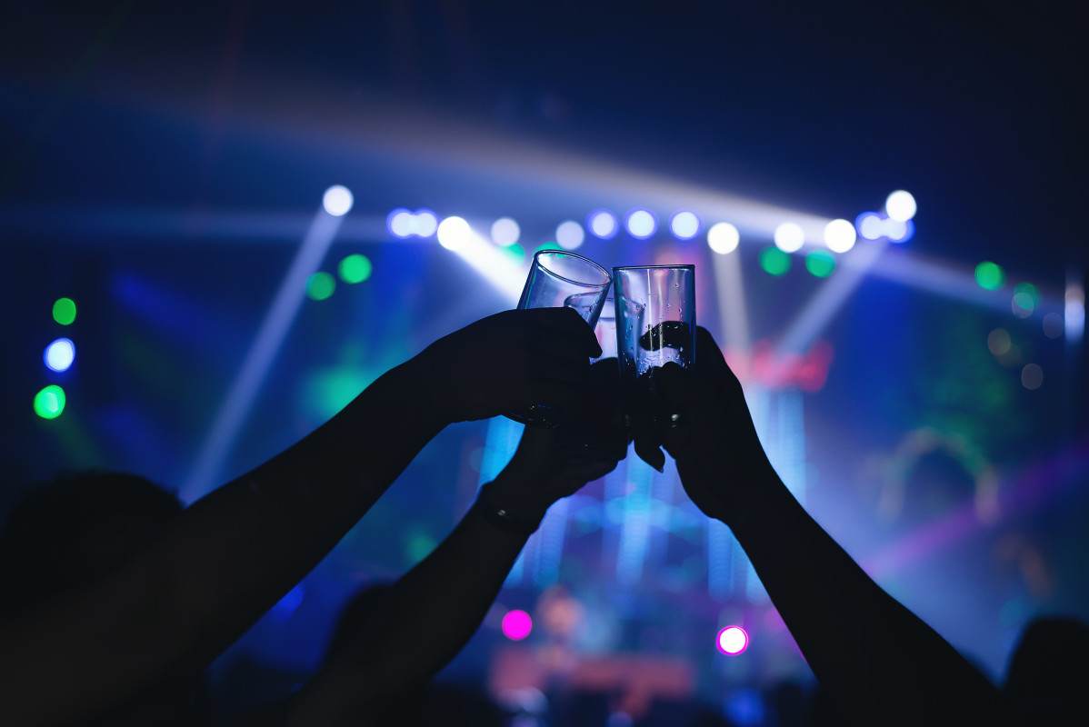Friends clinking drink glasses in modern bar
